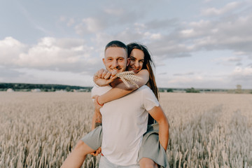 Young couple in love outdoor.Stunning sensual outdoor portrait of young stylish fashion couple posing in summer in field