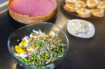Healthy food in the kitchen. Fresh salad and cheesecake. Vegetarian concept. Hipster lunches.