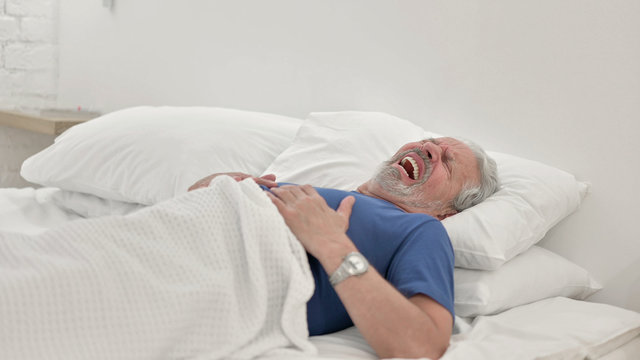 Senior Old Man Waking Up In Bed With Chest Pain