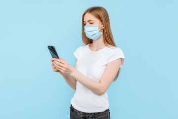 woman wearing a protective medical mask on her face uses a smartphone while. Air pollution, virus, coronavirus