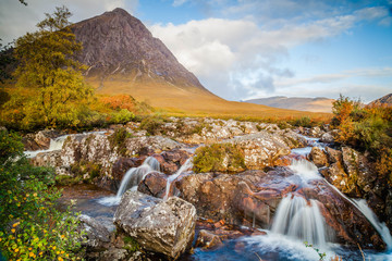 Small waterfall with Buachaille Etive Mor, mountain in Glencoe