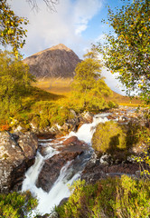 Small waterfall with Buachaille Etive Mor, mountain in Glencoe