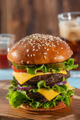 Big sandwich - hamburger burger with beef, tomato, cheese, pickled cucumber and red onion.