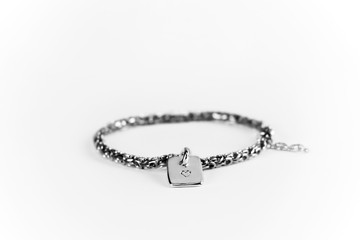 Romantic gesture giving a bracelet with message of love. Heart stamped on the sterling silver tag.
