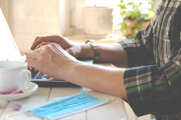 Fototapeta premium Freelancer works in home office during coronavirus pandemic. Open laptop with blank screen on a white background