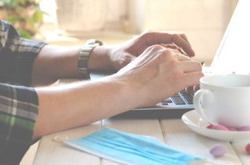 Freelancer works in home office during coronavirus pandemic. Open laptop with blank screen on a white background