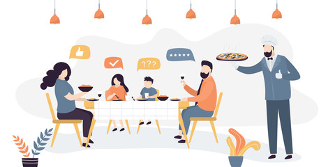 The family eats in a pizzeria or Italian restaurant. Handsome chef or waiter with pizza on a tray.