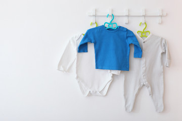 Baby clothes on a hanger. Place for text, minimalism.