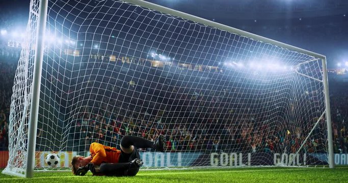 Goalkeeper fails to catch the ball that flies with flames animation on the professional soccer stadium. Stadium is made in 3d.