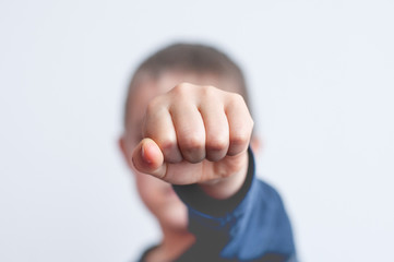 Child with clenched fist. Unrecognizable face. Very low depth of field.