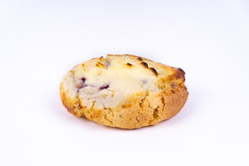 A cookie cheesecake with blueberries on white background with copy space - angled view