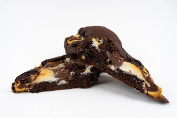 A cut cookie cake with chocolate on white background with copy space - angled view
