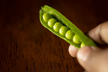 green peas in human hand