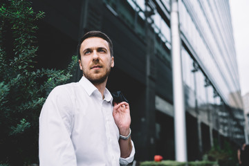 Independent businessman in white shirt standing on street