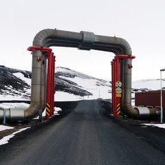 Steam pipelines from a power plant in northern Iceland in winter with snow al around