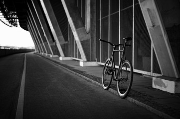 Black fixedgear road bicycle on a side of the road
