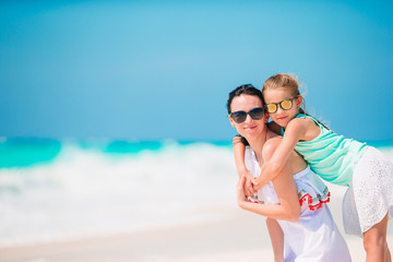 Fototapeta premium Beautiful mother and daughter on the beach