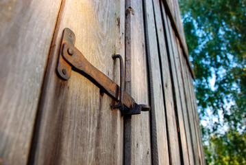 old rusty latch on old wooden doors