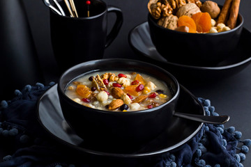 Traditional Dessert Asure,Noah Pudding in stylish,black color bowl on the black surface.Conceptual design.