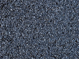 Rough texture of asphalt crumb of blue-gray color. Pink rough wall.