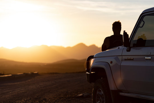 man and 4x4 sunset silhouette 