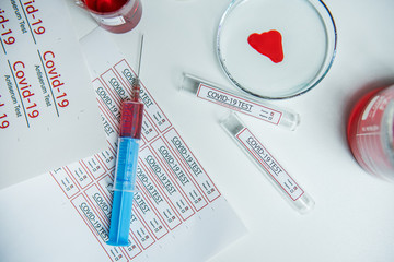 Coronavirus covid19 infected blood sample in sample tube on table in corona virus laboratory
