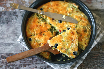 Selective focus. Frying pan with a pie with cabbage and olives. Freshly baked homemade cabbage pie. Healthy food.