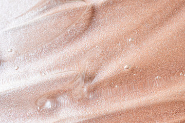 Transparent cosmetic antibacterial gel close-up. The concept of cleanliness. Antiseptic. Mother of pearl pink background.