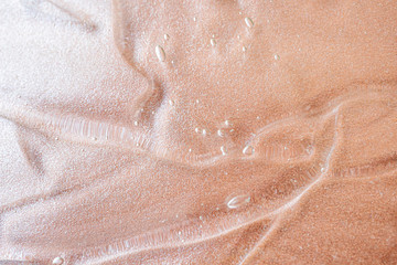 Transparent cosmetic antibacterial gel close-up. The concept of cleanliness. Antiseptic. Mother of pearl pink background.