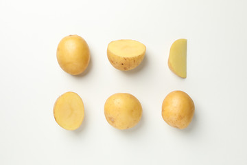 Flat lay with young potato on white background, top view