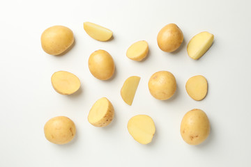 Flat lay with young potato on white background, top view