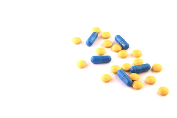 yellow and blue tablets on a white background