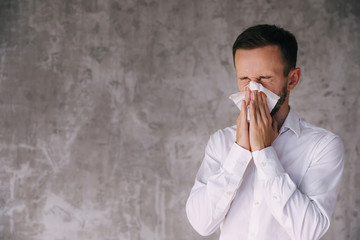 allergic guy caught cold sitting at office, having respiratory d