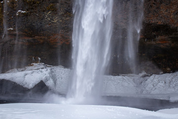 waterfall falls to the ground in icelandic wilderness