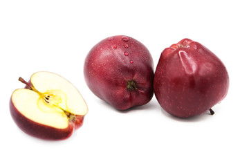 Fresh organic apples and half apple in dew drops isolated on white background.