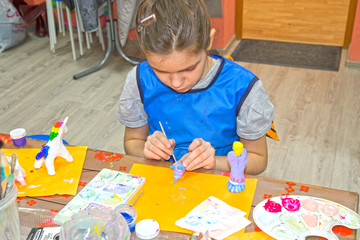 Passion and hobbies. Children do needlework, paint on clay figures
