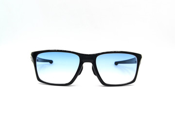 Stylish black glasses with blue tinted lens isolated on white background.