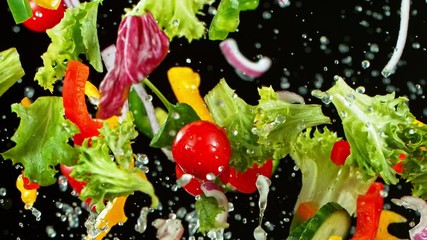 Super Slow Motion Shot of Flying Fresh Vegetables and Water Splash on Black Background at 1000fps. - Powered by Adobe