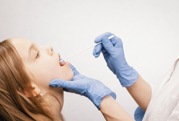 Pediatrician taking saliva test sample