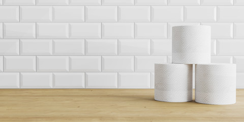 Toilet paper rolls on wooden and white tile background. Toilet paper roll on a table, background