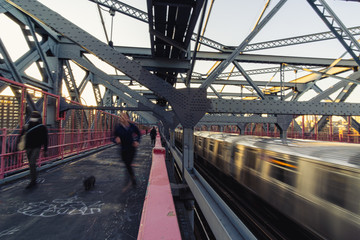 Train passing by and runner on the manhattan bridge