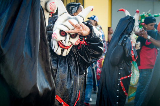 closeup man in demon masquerade costume poses for photo at dominican carnival