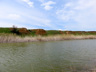 Blue sky with clouds over a river.