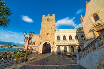 Fototapeta na wymiar Empty Square Piazza IX Aprile with San Giuseppe church and Clock Tower in Taormina, Sicily, Italy.