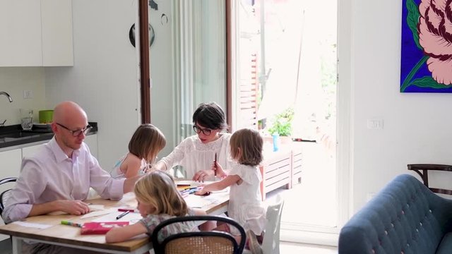 Family with three children home schooling indoor - teaching, mentoring, education concept