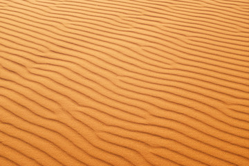Desert sand patterns in rich orange color for a hot summer background.