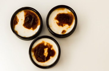 Traditional Turkish Style Baked Rice Pudding in casserole,clay dessert bowls,on white surface with copy space,top view