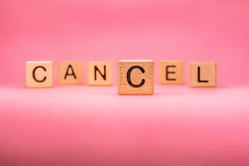 CANCEL word made with building blocks, business concept. Word CANCEL on pink background. Event cancellation. Cancelled concept. Word cancel on pink background. Travel advice. Protect from coronavirus