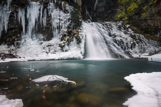 The dramatic "Reinbach" waterfall in South Tyrol, Italy in winter