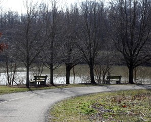 The park benches overlooking the lake in the park.